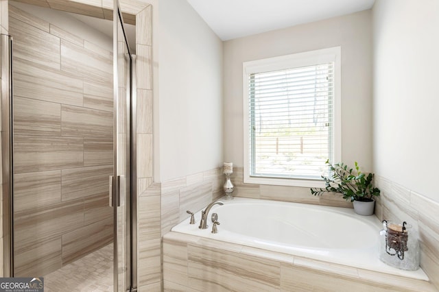 bathroom featuring separate shower and tub