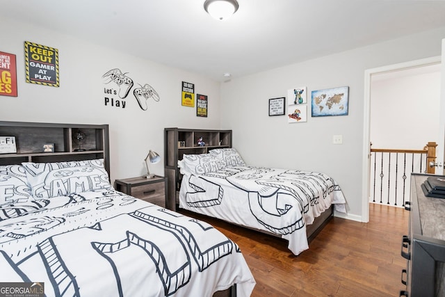 bedroom with dark hardwood / wood-style flooring