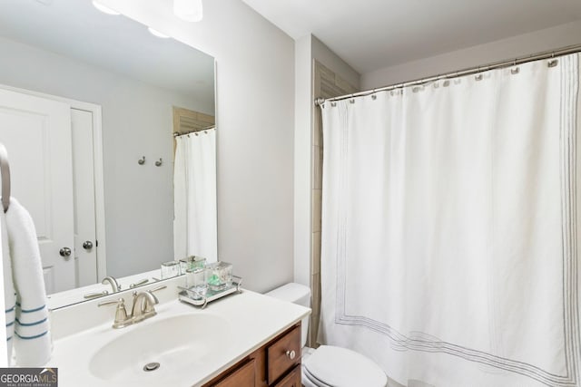 bathroom featuring toilet and vanity