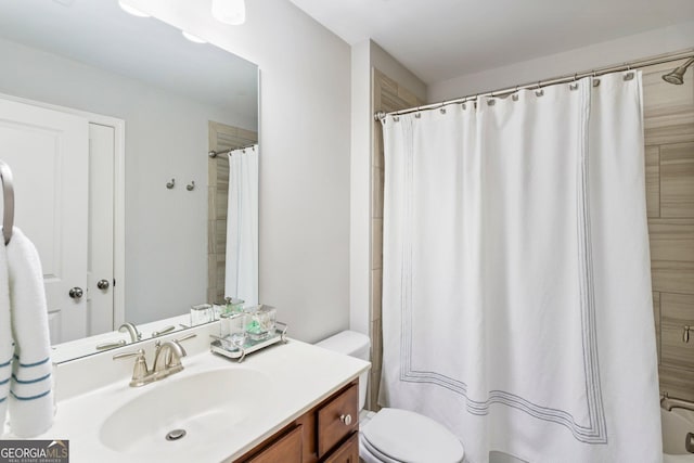 bathroom featuring toilet, walk in shower, and vanity