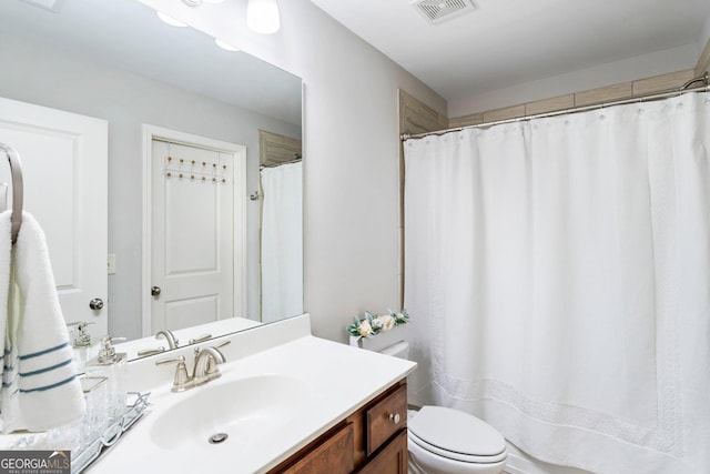 bathroom featuring toilet and vanity