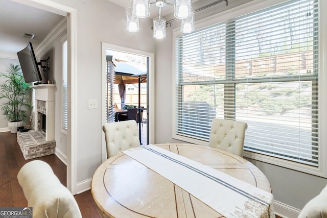 dining room with dark wood-type flooring and ornamental molding