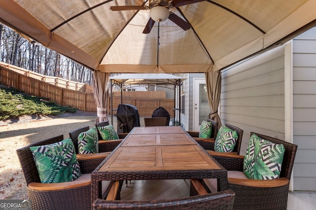 view of patio featuring ceiling fan and a gazebo