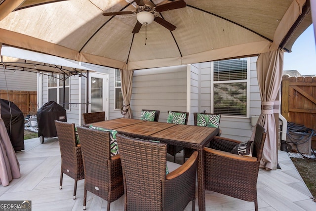 exterior space with ceiling fan, a gazebo, and a grill