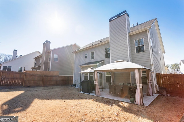 back of property featuring a patio area and a gazebo