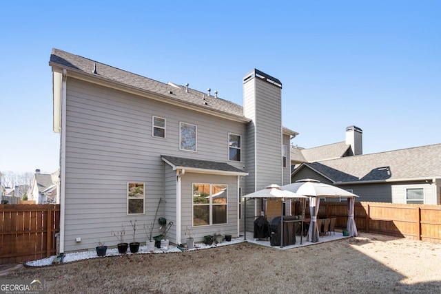 back of house with a gazebo and a patio area