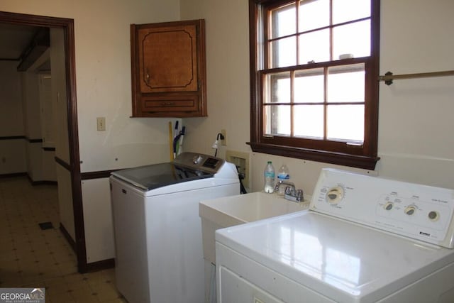 laundry area with washer and dryer, cabinet space, and light floors