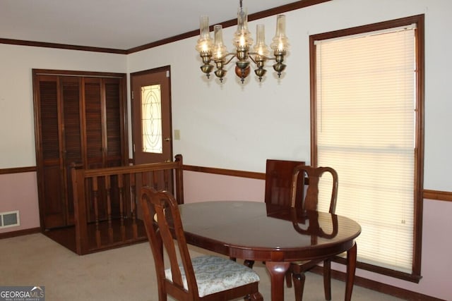 carpeted dining room featuring visible vents and crown molding