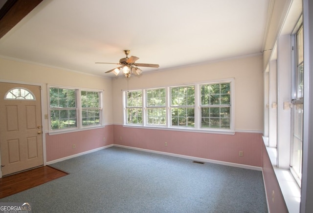 unfurnished sunroom with visible vents and a ceiling fan