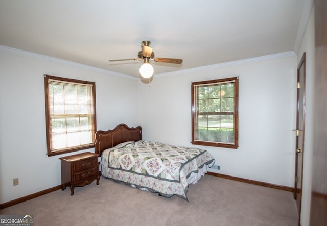 bedroom with ornamental molding, carpet flooring, baseboards, and a ceiling fan