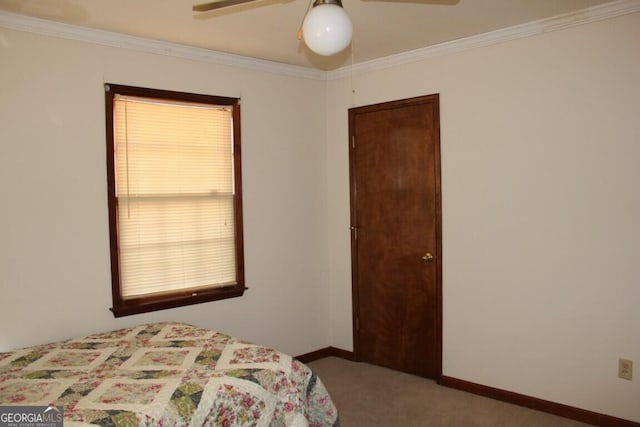 bedroom featuring a ceiling fan, carpet, ornamental molding, and baseboards