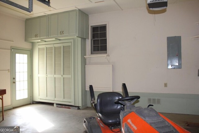 interior space featuring a garage, electric panel, and concrete flooring