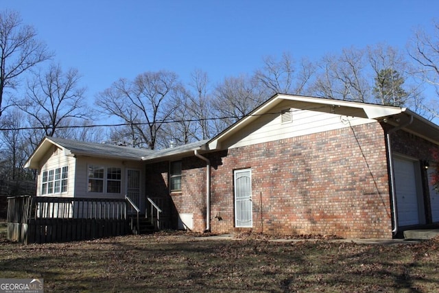 view of home's exterior with a garage and brick siding