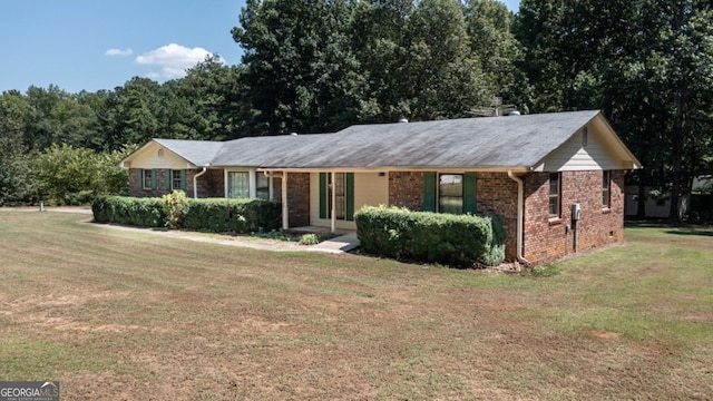 ranch-style home with a front yard, crawl space, and brick siding