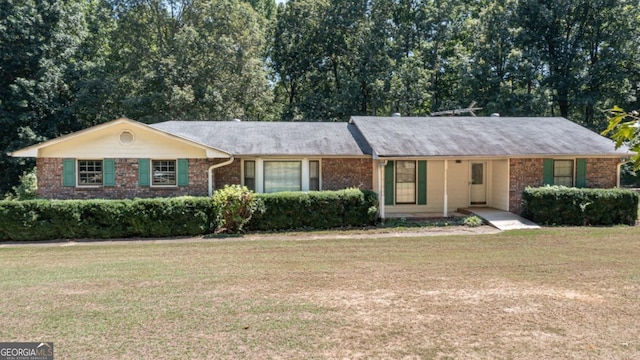 ranch-style house with brick siding and a front lawn