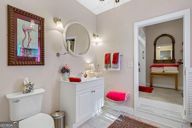 bathroom with toilet, tile patterned flooring, and vanity