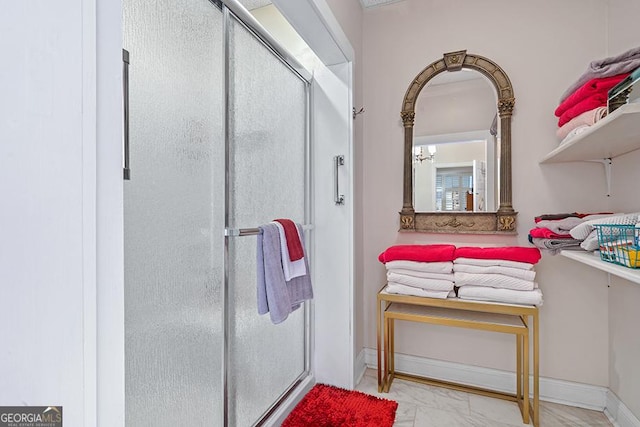 bathroom with an enclosed shower and a chandelier