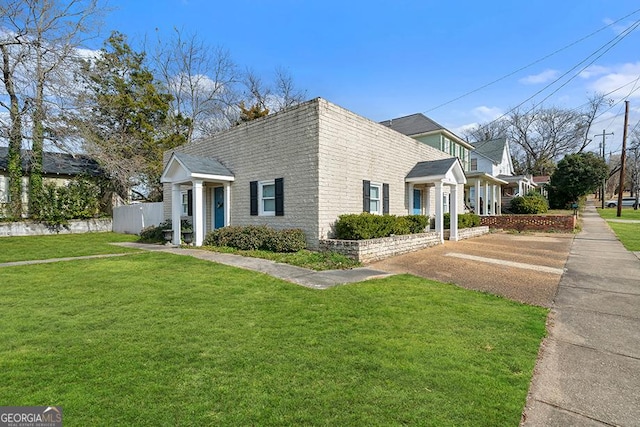 view of side of property featuring a yard