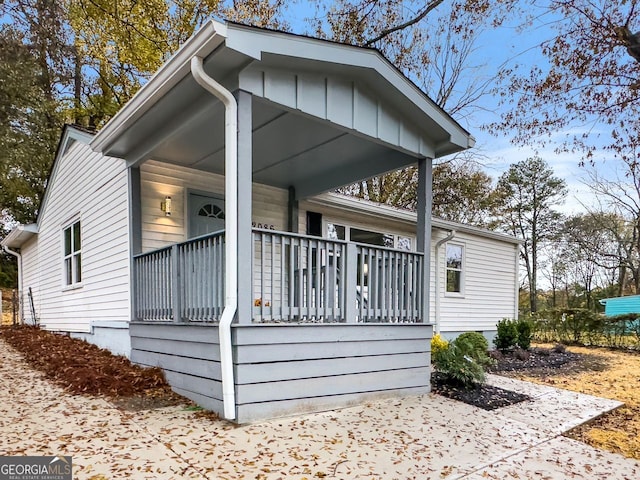 view of side of property featuring covered porch