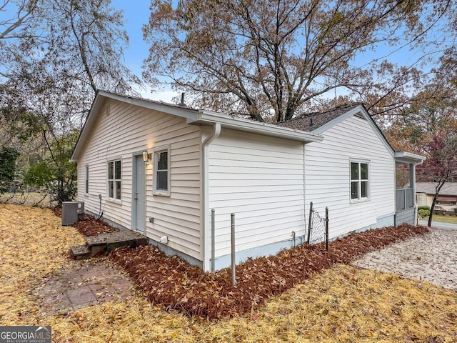 view of side of property with central air condition unit