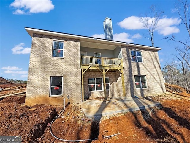 rear view of house featuring a patio area and a balcony