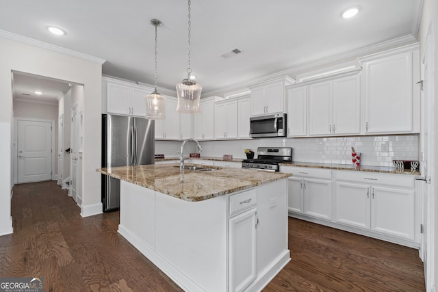 kitchen featuring white cabinetry, a center island with sink, stainless steel appliances, pendant lighting, and sink