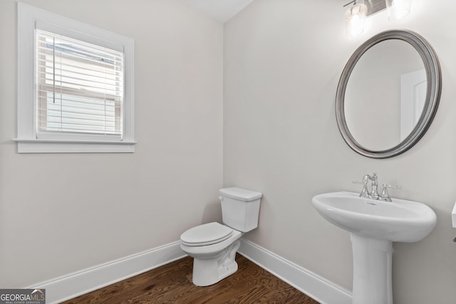 bathroom with toilet, sink, and hardwood / wood-style floors