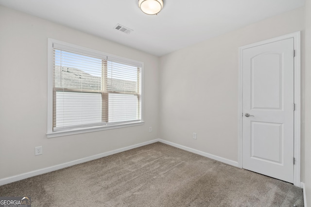 empty room with light colored carpet