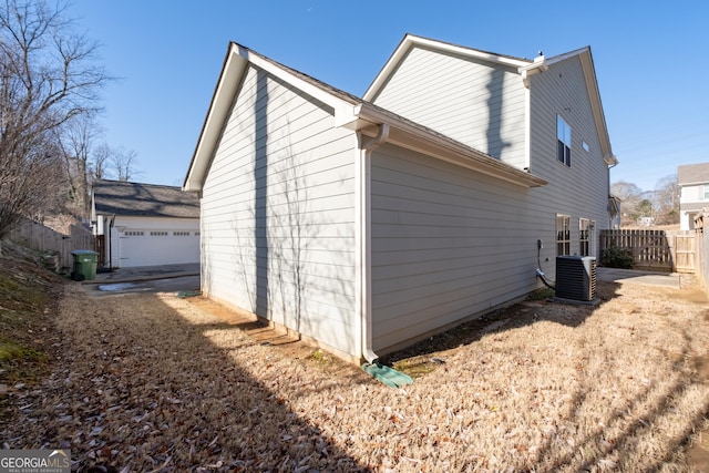 view of home's exterior with central AC unit and a garage