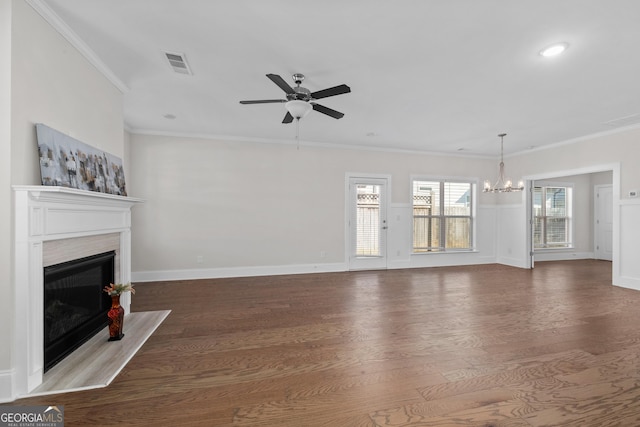 unfurnished living room featuring ornamental molding, ceiling fan with notable chandelier, and hardwood / wood-style flooring