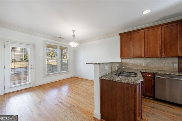 kitchen with dishwasher, sink, ornamental molding, pendant lighting, and stone countertops