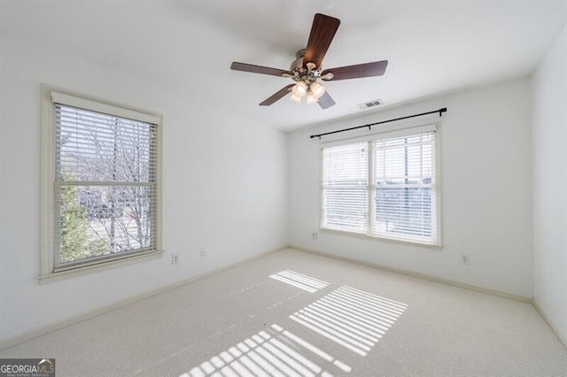 unfurnished room featuring ceiling fan and light colored carpet