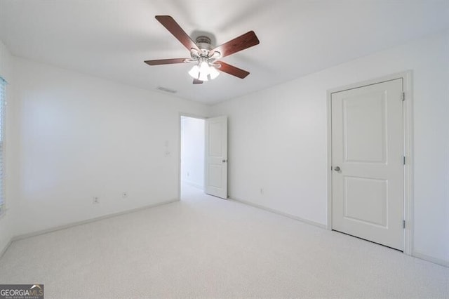 carpeted empty room with ceiling fan