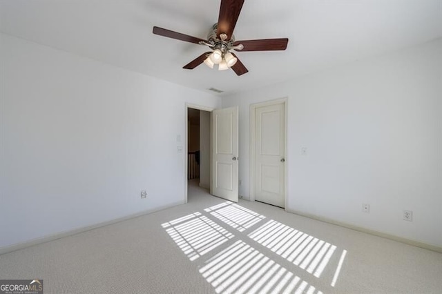 unfurnished bedroom featuring ceiling fan and light carpet