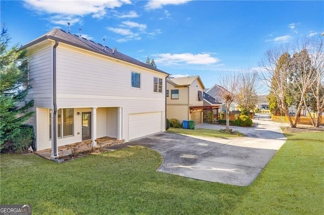 view of home's exterior with a garage and a yard