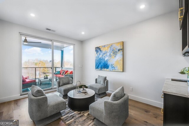 sitting room featuring baseboards, light wood finished floors, visible vents, and recessed lighting