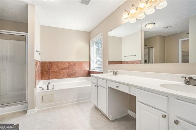 3055 Cooper Woods Ln, Loganville, GA 30052 - full bathroom with a shower stall, a garden tub, double vanity, and a textured ceiling