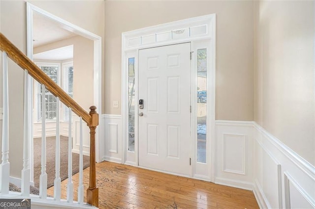 3055 Cooper Woods Ln, Loganville, GA 30052 - entryway with a decorative wall, stairs, hardwood / wood-style floors, and wainscoting