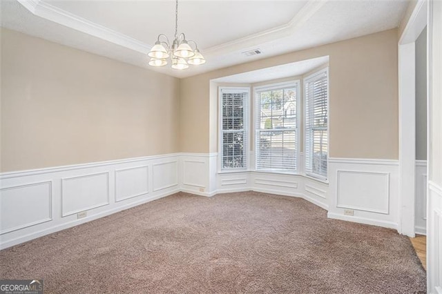 3055 Cooper Woods Ln, Loganville, GA 30052 - carpeted spare room with a chandelier, ornamental molding, a raised ceiling, wainscoting, and a decorative wall