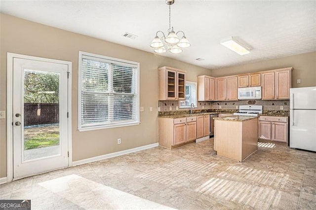3055 Cooper Woods Ln, Loganville, GA 30052 - kitchen with white appliances, a chandelier, plenty of natural light, and light brown cabinets