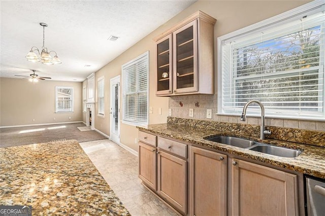 3055 Cooper Woods Ln, Loganville, GA 30052 - kitchen featuring a chandelier, dark stone counters, tasteful backsplash, glass insert cabinets, and decorative light fixtures