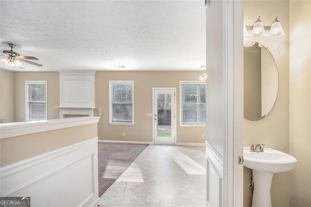 3055 Cooper Woods Ln, Loganville, GA 30052 - bathroom featuring plenty of natural light, ceiling fan, and a textured ceiling