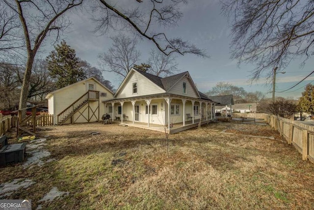 back of property featuring a yard