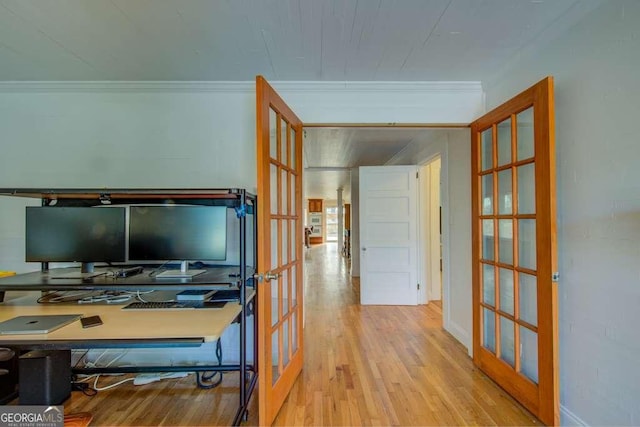 home office featuring crown molding, french doors, and light wood-type flooring