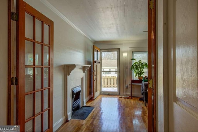 entryway with wood-type flooring and ornamental molding