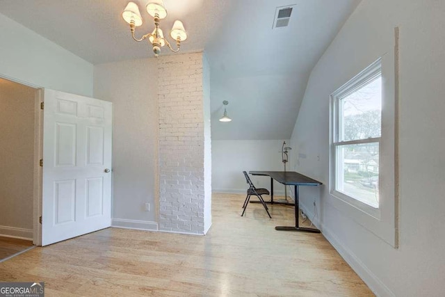 additional living space with light wood-type flooring, an inviting chandelier, and vaulted ceiling