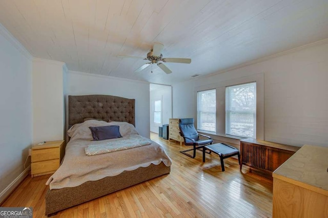 bedroom with ceiling fan, ornamental molding, and hardwood / wood-style floors