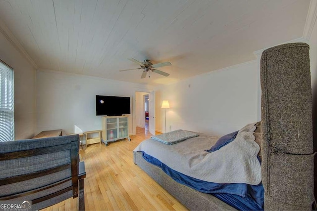 bedroom with ceiling fan, ornamental molding, and hardwood / wood-style floors