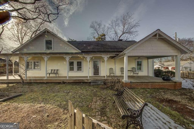 back of house featuring a porch