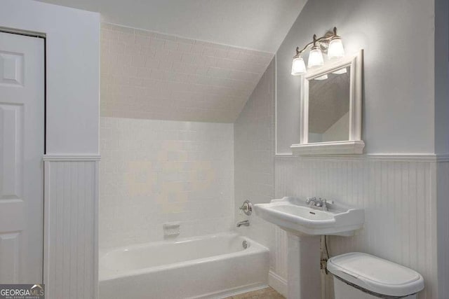 bathroom with toilet and vaulted ceiling